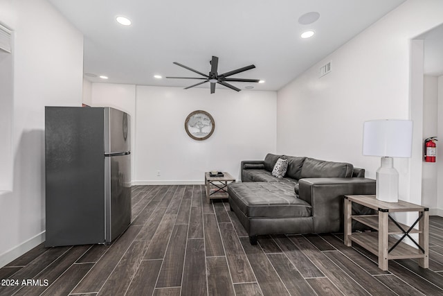 living room featuring dark hardwood / wood-style flooring and ceiling fan