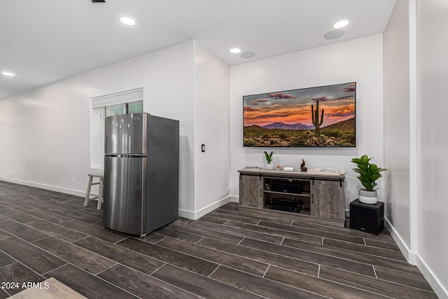 interior space with stainless steel refrigerator and dark hardwood / wood-style floors