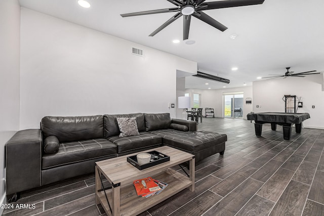 living room with pool table, ceiling fan, and dark wood-type flooring