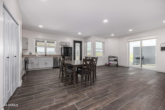 dining area with dark hardwood / wood-style flooring and a wealth of natural light