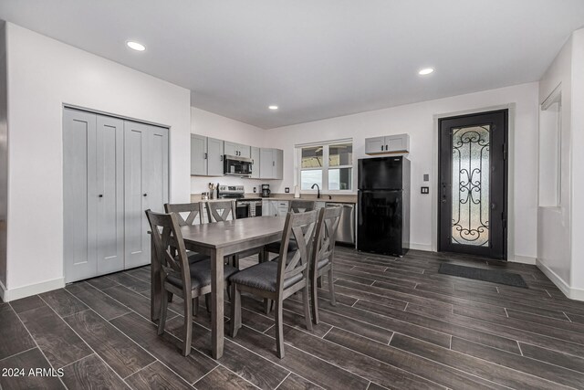 dining area with dark hardwood / wood-style floors and sink