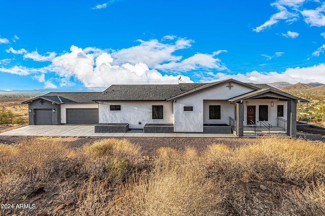 single story home featuring a garage and a mountain view