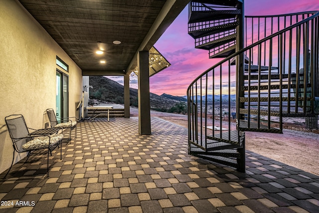 patio terrace at dusk with a mountain view