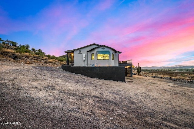 property exterior at dusk featuring a mountain view