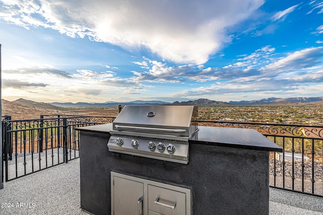 view of patio / terrace featuring area for grilling, a mountain view, and a grill