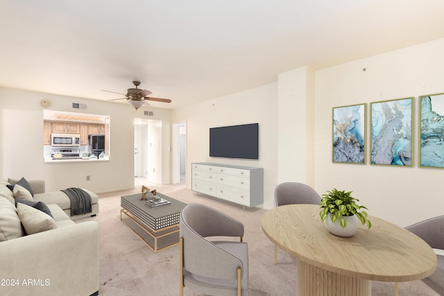 living room featuring light carpet and ceiling fan