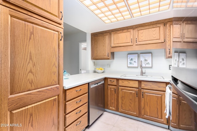 kitchen with dishwasher, light tile patterned floors, and sink