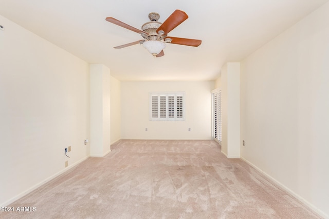 carpeted empty room featuring ceiling fan