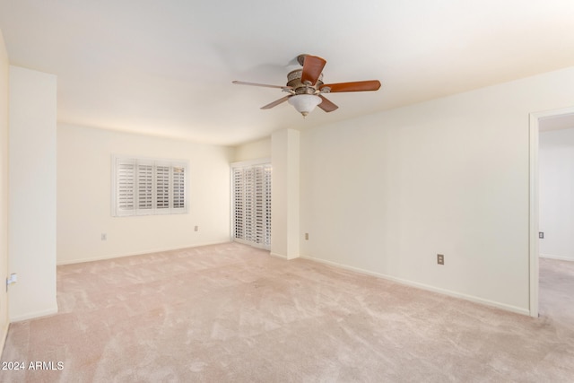 unfurnished room featuring ceiling fan and light colored carpet