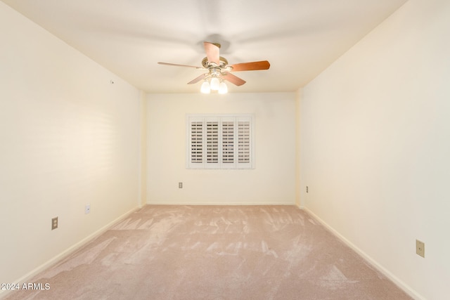 empty room featuring light carpet and ceiling fan