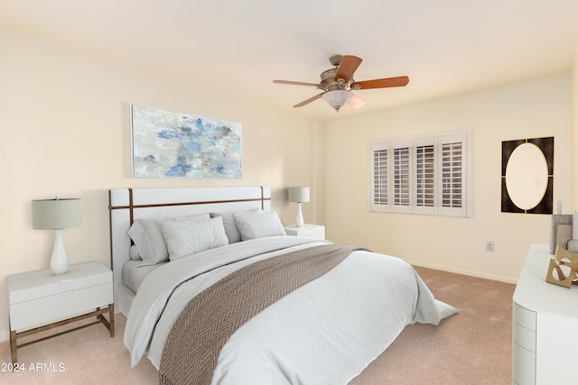 bedroom with ceiling fan and light carpet