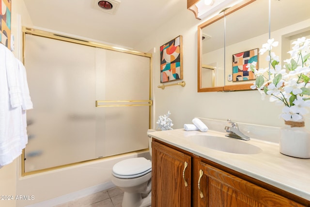 full bathroom featuring tile patterned flooring, vanity, toilet, and shower / bath combination with glass door