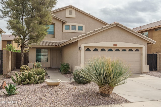 view of front of home with an attached garage, fence, driveway, and stucco siding