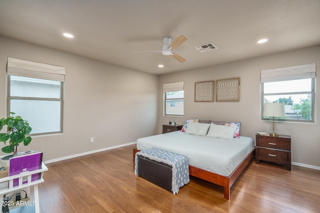 bedroom featuring visible vents, recessed lighting, baseboards, and wood finished floors