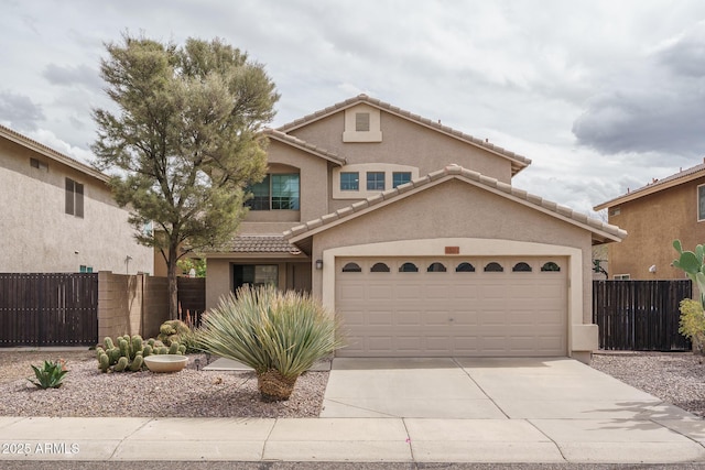 view of front of home with stucco siding, concrete driveway, and fence