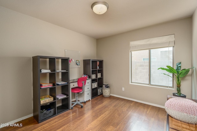 home office with wood finished floors and baseboards