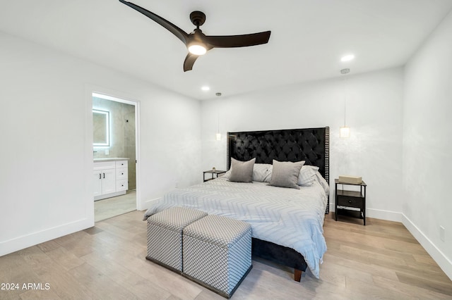 bedroom with ceiling fan, light hardwood / wood-style flooring, and ensuite bathroom