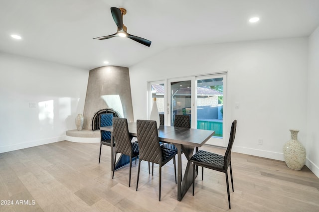 dining space featuring ceiling fan, light hardwood / wood-style floors, and lofted ceiling