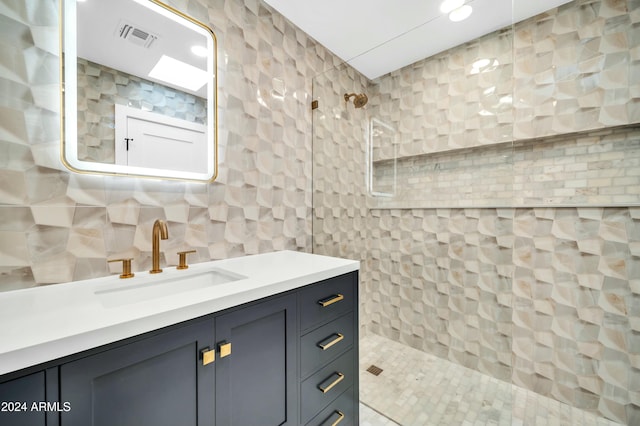 bathroom with tile patterned flooring, a shower, and tile walls