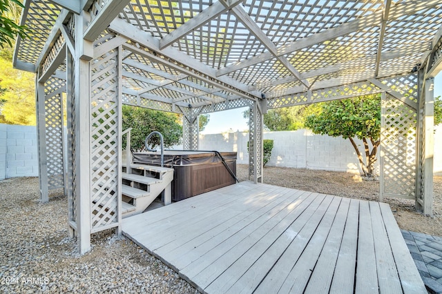 wooden terrace featuring a hot tub