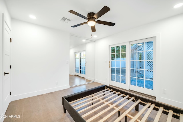 unfurnished bedroom featuring light wood-type flooring and ceiling fan