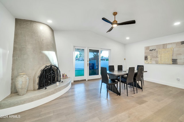 dining area with ceiling fan, light hardwood / wood-style flooring, and lofted ceiling