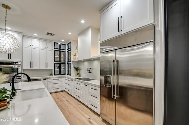 22406 S 173rd Way, Gilbert, AZ 85298 - kitchen with appliances with stainless steel finishes, light wood-style floors, white cabinetry, recessed lighting, and hanging light fixtures