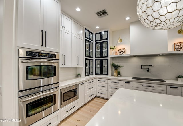 22406 S 173rd Way, Gilbert, AZ 85298 - kitchen featuring appliances with stainless steel finishes, open shelves, light stone countertops, light wood finished floors, and decorative backsplash