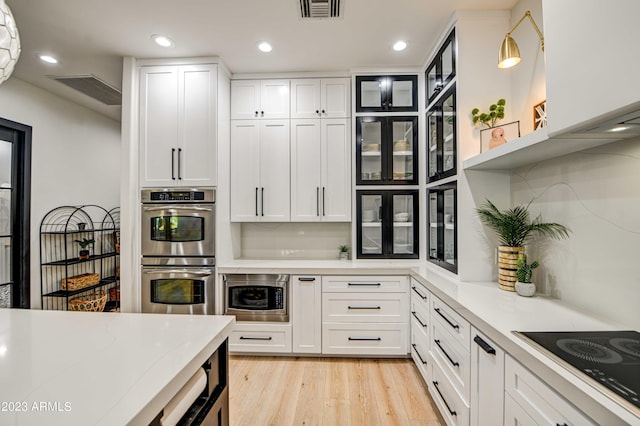 22406 S 173rd Way, Gilbert, AZ 85298 - kitchen with stainless steel appliances, white cabinetry, light wood-type flooring, recessed lighting, and glass insert cabinets