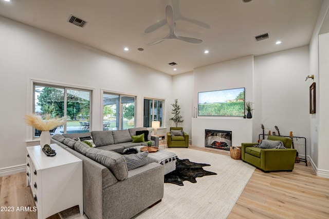 22406 S 173rd Way, Gilbert, AZ 85298 - living area featuring light wood finished floors, ceiling fan, recessed lighting, plenty of natural light, and a fireplace