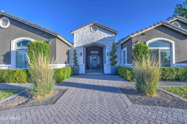 22406 S 173rd Way, Gilbert, AZ 85298 - view of front of house with stone siding, stucco siding, and a tile roof