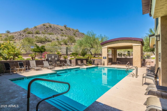 view of swimming pool featuring a mountain view and a patio