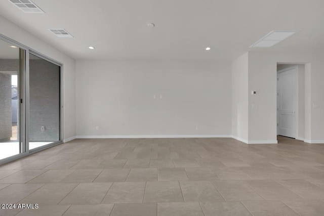 empty room with recessed lighting, visible vents, and baseboards