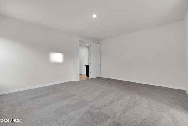 carpeted spare room featuring baseboards and recessed lighting