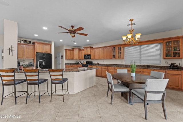 3018 E Vernon St, Gilbert, AZ 85298 - kitchen with black appliances, a kitchen bar, glass insert cabinets, brown cabinets, and recessed lighting