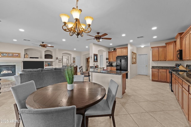 3018 E Vernon St, Gilbert, AZ 85298 - dining area featuring ceiling fan, a glass covered fireplace, light tile patterned flooring, recessed lighting, and a chandelier