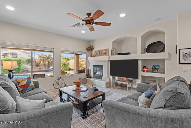 3018 E Vernon St, Gilbert, AZ 85298 - living area with ceiling fan, a tiled fireplace, recessed lighting, and built in features