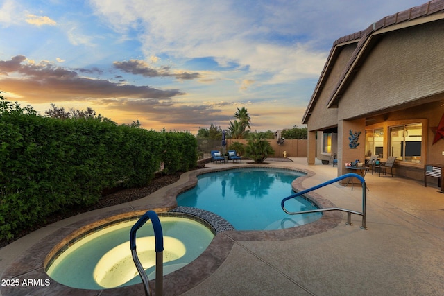 3018 E Vernon St, Gilbert, AZ 85298 - pool at dusk with a pool with connected hot tub, a patio area, and a fenced backyard