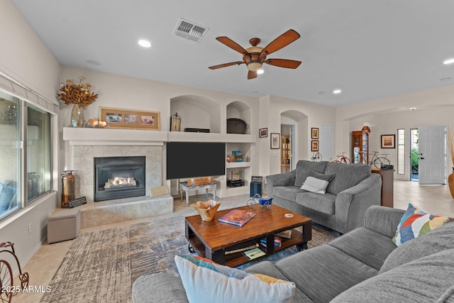 3018 E Vernon St, Gilbert, AZ 85298 - tiled living room with a tile fireplace, recessed lighting, ceiling fan, and built in shelves