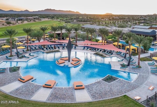 view of pool at dusk