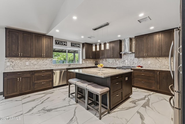 5101 E Paradise Dr, Scottsdale, AZ 85254 - kitchen featuring stainless steel appliances, wall chimney range hood, a center island, light marble finish flooring, and dark brown cabinets