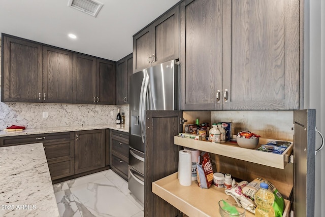 5101 E Paradise Dr, Scottsdale, AZ 85254 - kitchen featuring stainless steel fridge with ice dispenser, dark brown cabinets, light marble finish floors, decorative backsplash, and recessed lighting