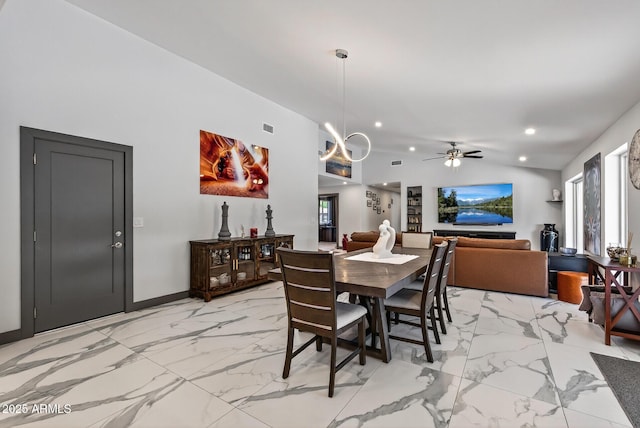 5101 E Paradise Dr, Scottsdale, AZ 85254 - dining area with light marble finish flooring, lofted ceiling, recessed lighting, a ceiling fan, and a chandelier