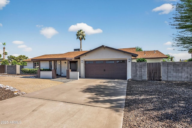 5101 E Paradise Dr, Scottsdale, AZ 85254 - ranch-style home with concrete driveway, an attached garage, and a gate