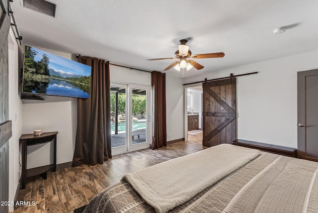 5101 E Paradise Dr, Scottsdale, AZ 85254 - bedroom with a barn door, access to exterior, wood finished floors, a ceiling fan, and ensuite bath