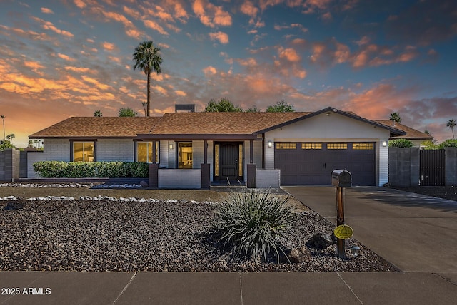 5101 E Paradise Dr, Scottsdale, AZ 85254 - single story home featuring a garage, driveway, brick siding, and a porch