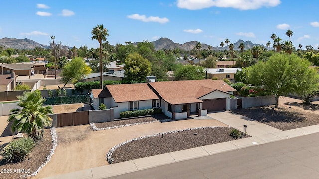 5101 E Paradise Dr, Scottsdale, AZ 85254 - view of front facade with concrete driveway, a gate, a mountain view, and a residential view