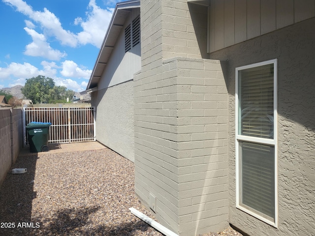 view of side of property featuring fence