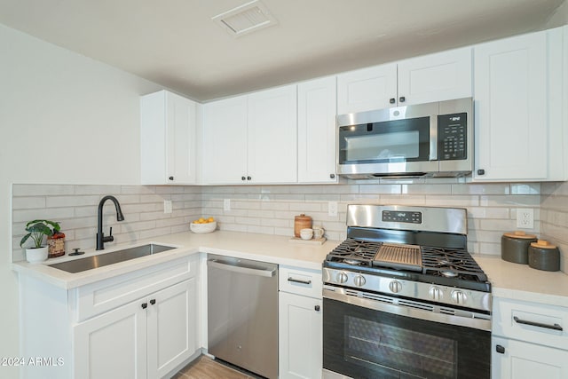 kitchen featuring white cabinetry, sink, and appliances with stainless steel finishes