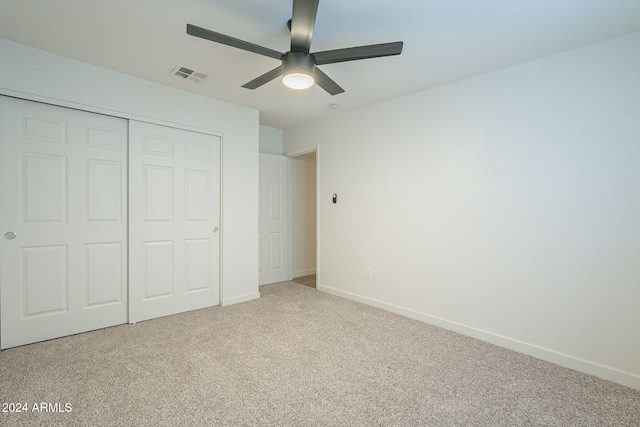 unfurnished bedroom featuring carpet flooring, ceiling fan, and a closet